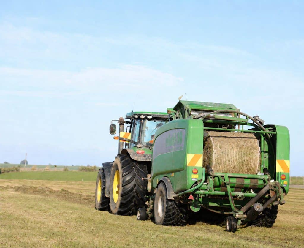 Hay baler using Kiwi Econet bale natural fibre netting