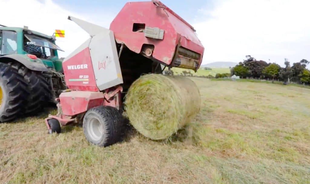 Welger baler with hay bale wrapped with Kiwi EcoNet bale net