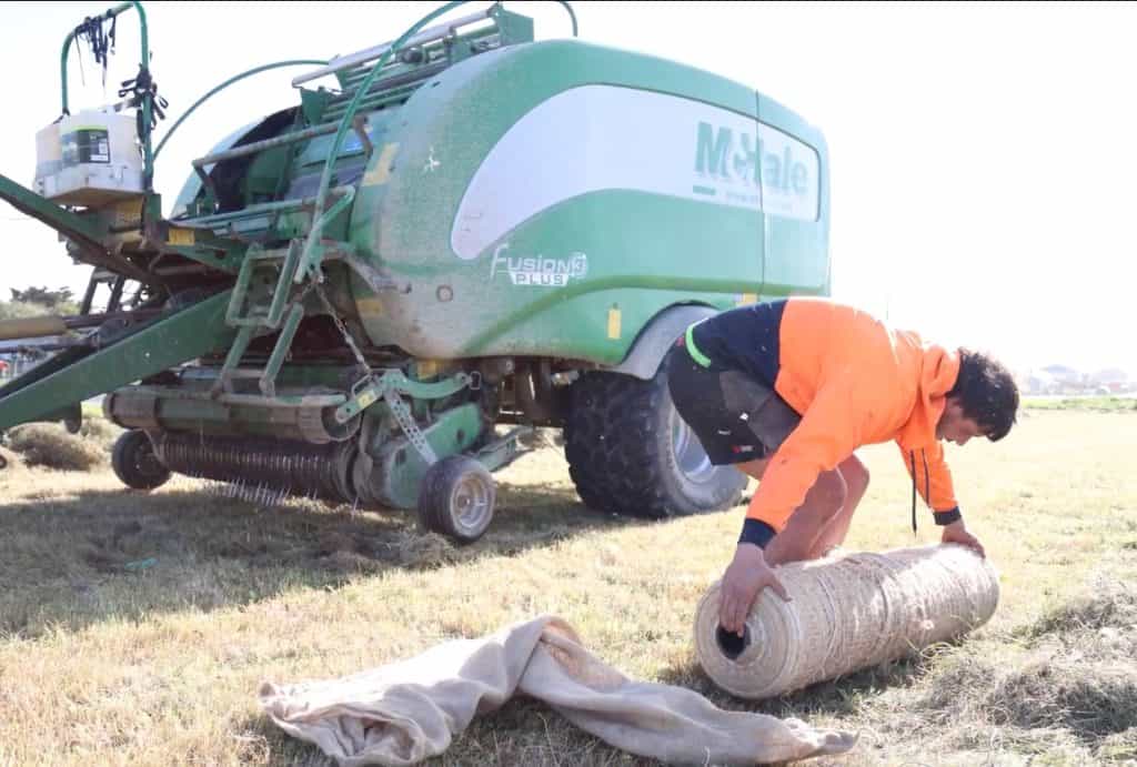 Unpacking new Kiwi EcoNet roll to install on McHale hay baler